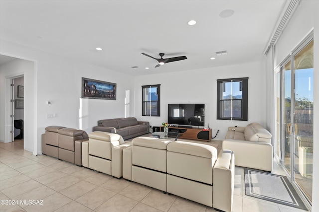 living room featuring ceiling fan and light tile patterned flooring