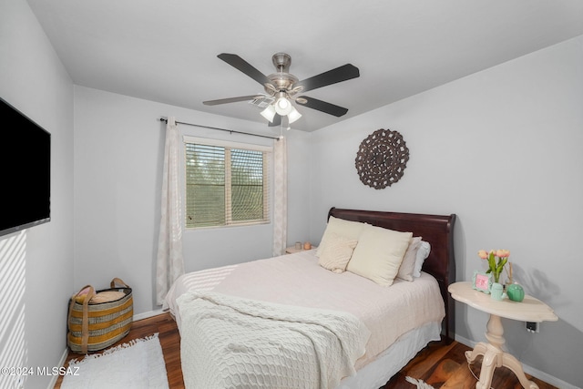 bedroom with dark wood-type flooring and ceiling fan