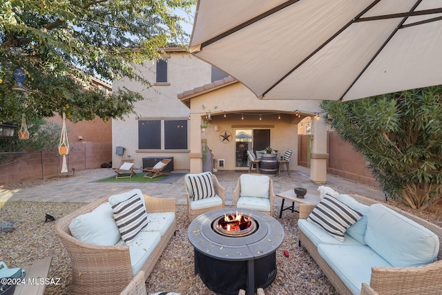 view of patio / terrace with an outdoor living space with a fire pit