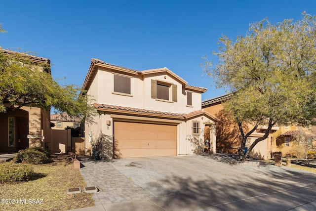 mediterranean / spanish-style house with a garage