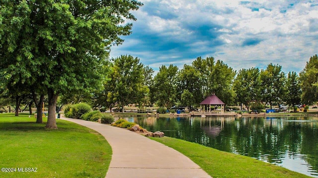 view of community featuring a gazebo, a water view, and a lawn