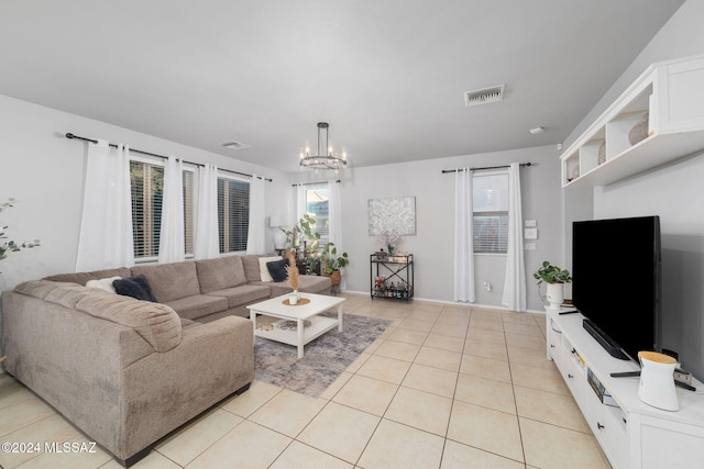 tiled living room featuring a notable chandelier