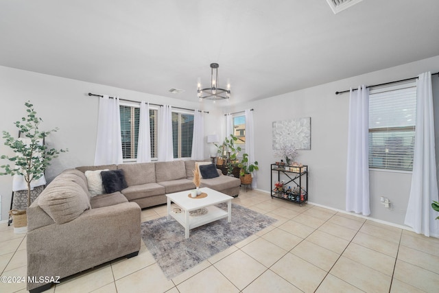 living room with an inviting chandelier and light tile patterned floors