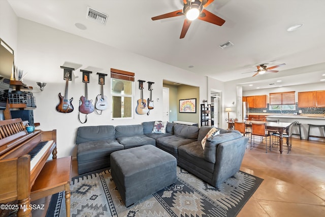 tiled living room with ceiling fan