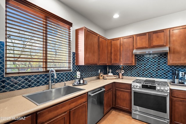 kitchen with light tile patterned flooring, sink, and stainless steel appliances