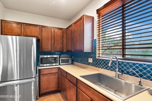 kitchen with tasteful backsplash, sink, and stainless steel appliances