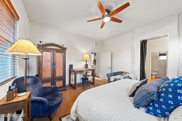 bedroom featuring ceiling fan, ensuite bathroom, and wood-type flooring