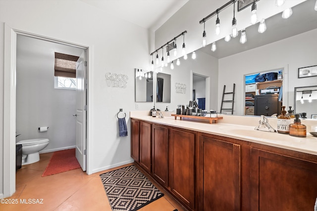 bathroom with tile patterned floors, vanity, and toilet