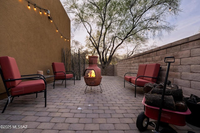 patio terrace at dusk with an outdoor fire pit