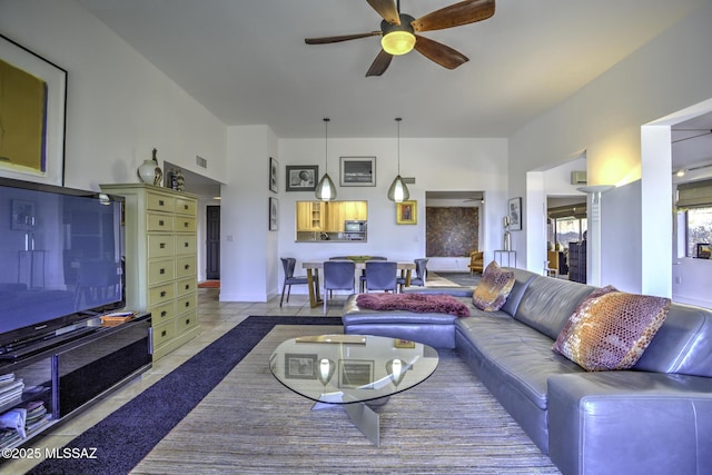 living room with light tile patterned floors and ceiling fan