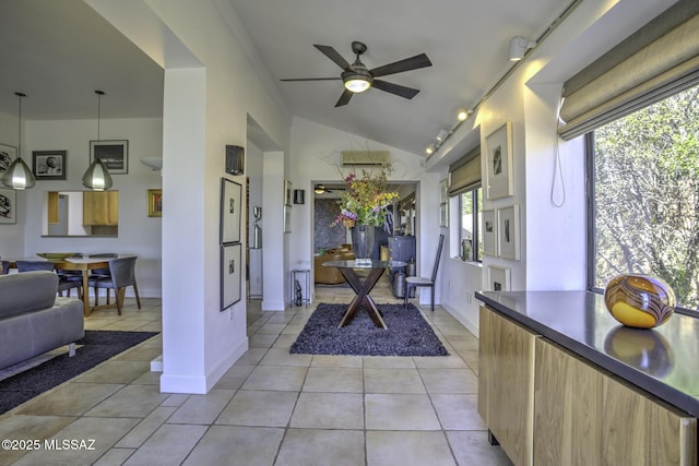 interior space featuring vaulted ceiling, ceiling fan, and track lighting