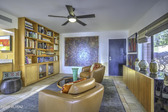 sitting room featuring light tile patterned floors and ceiling fan