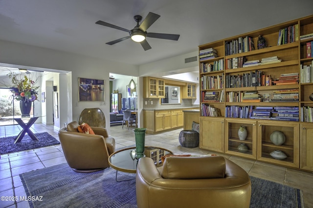 living area featuring light tile patterned flooring and ceiling fan