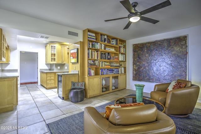 sitting room featuring light tile patterned floors and ceiling fan