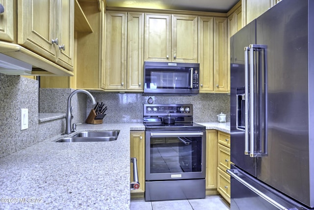 kitchen with light stone counters, sink, high quality fridge, and stainless steel electric range oven