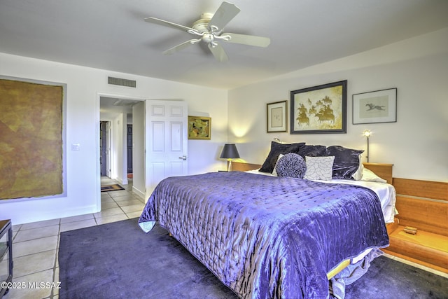 tiled bedroom featuring ceiling fan