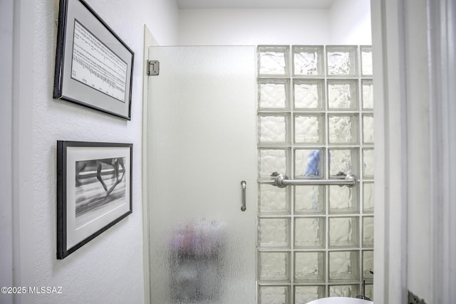 bathroom featuring a shower with door