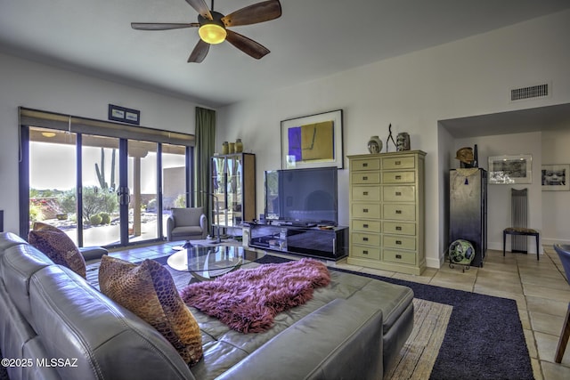 tiled living room featuring french doors and ceiling fan