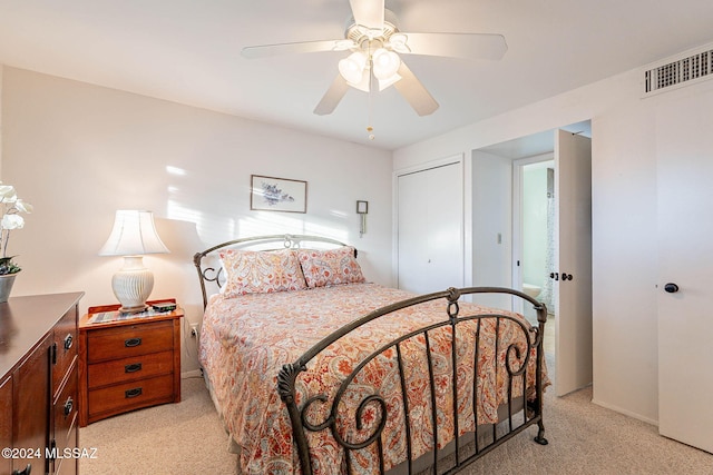 carpeted bedroom featuring ceiling fan and a closet