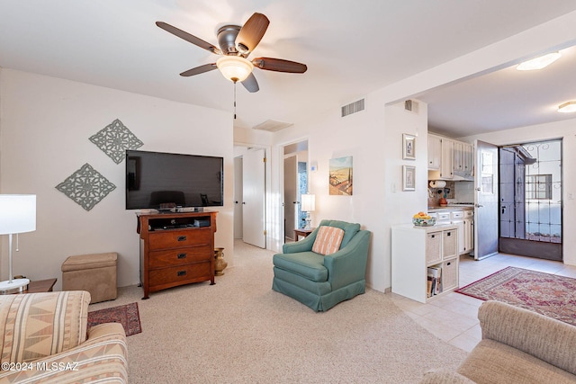 living room with ceiling fan and light tile patterned flooring