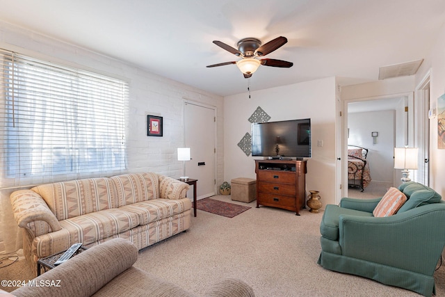 living room featuring ceiling fan and light colored carpet