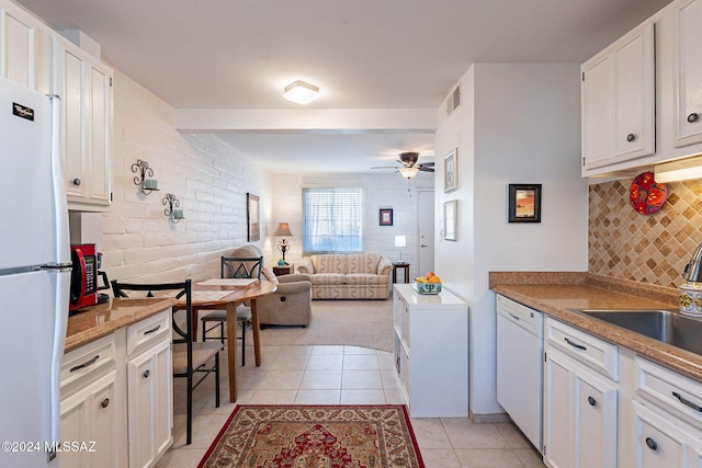 kitchen featuring ceiling fan, sink, light tile patterned flooring, white appliances, and white cabinets