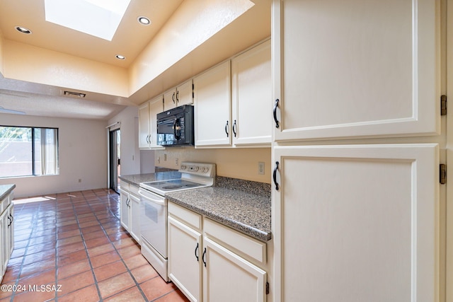 kitchen with white cabinets, electric stove, light tile patterned floors, and a skylight