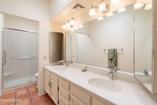 bathroom with tile patterned floors, vanity, toilet, and an enclosed shower