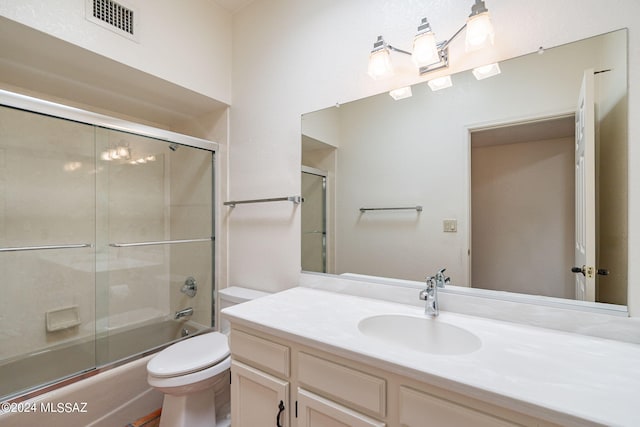 full bathroom featuring vanity, toilet, and enclosed tub / shower combo