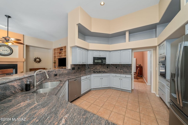 kitchen with black appliances, sink, light tile patterned floors, a high ceiling, and gray cabinets