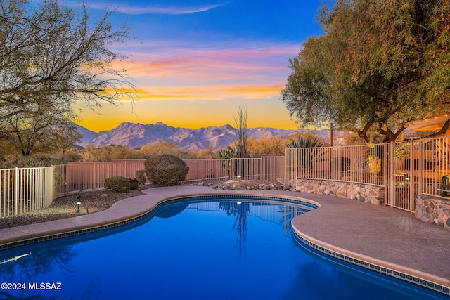 pool at dusk with a mountain view