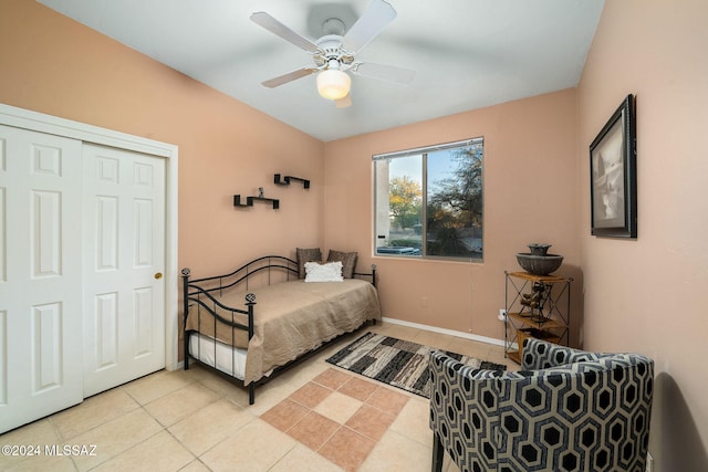 bedroom with ceiling fan, a closet, and light tile patterned flooring