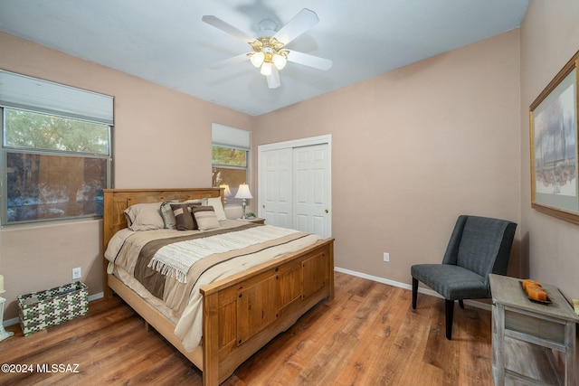 bedroom featuring ceiling fan, a closet, and hardwood / wood-style flooring