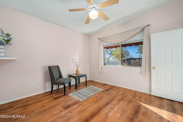 living area featuring hardwood / wood-style flooring and ceiling fan