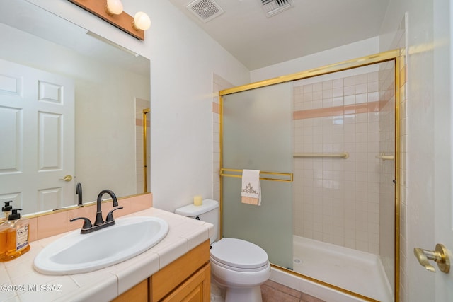 bathroom with vanity, toilet, and an enclosed shower