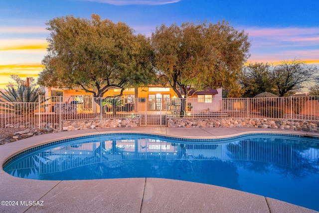 view of pool at dusk