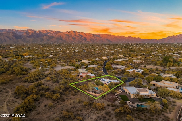 aerial view at dusk featuring a mountain view