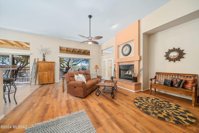 living room featuring ceiling fan and light hardwood / wood-style flooring