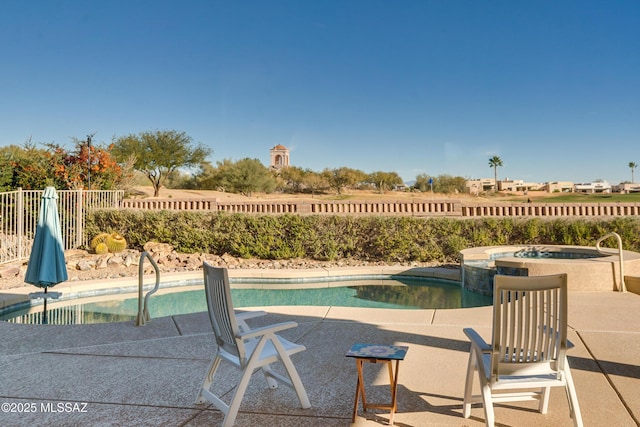 view of pool with an in ground hot tub and a patio