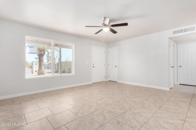 tiled empty room with ceiling fan