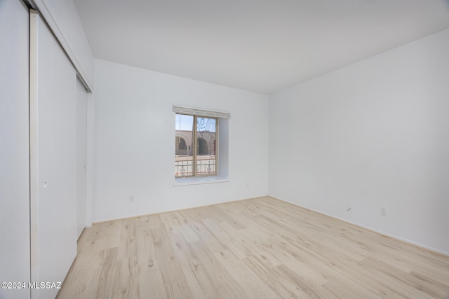 spare room with light hardwood / wood-style flooring