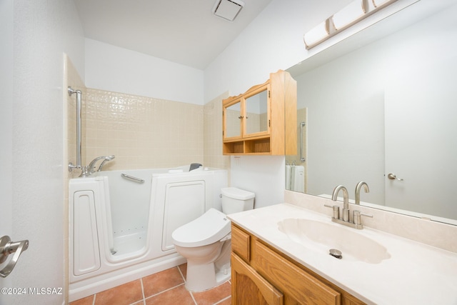 bathroom with tile patterned flooring, vanity, toilet, and a tub to relax in