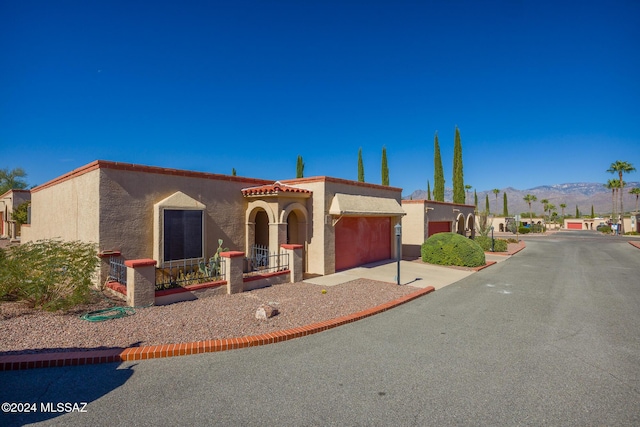 view of front facade featuring a mountain view and a garage