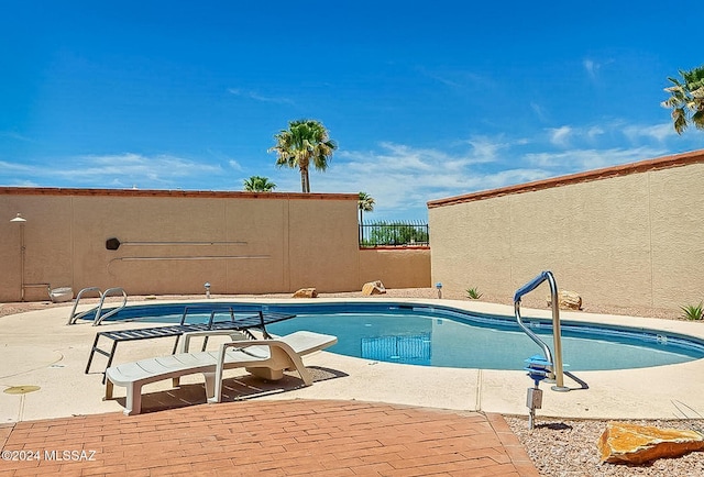 view of swimming pool featuring a patio