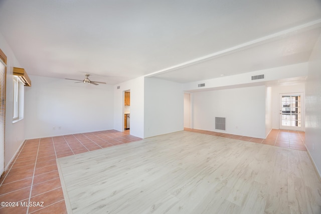 unfurnished living room with ceiling fan and light tile patterned flooring