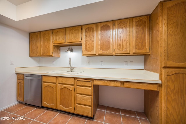 kitchen with dishwasher, built in desk, tile patterned floors, and sink