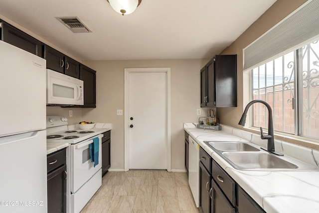 kitchen featuring white appliances and sink