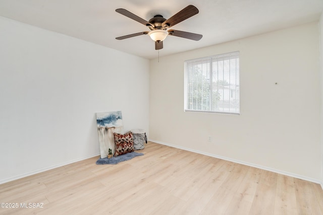 spare room featuring ceiling fan and light hardwood / wood-style floors