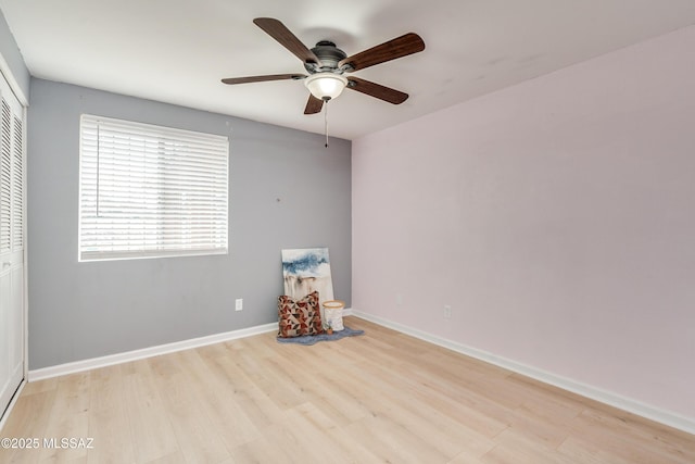 empty room with ceiling fan and light wood-type flooring