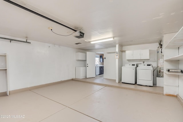 garage with separate washer and dryer, sink, a garage door opener, and water heater